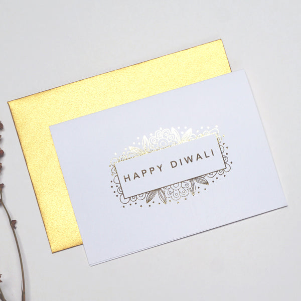 antdesigngifts.co.uk Diwali card in gold foil. Happy Diwali in box with a floral pattern. Handprinted in our studio. Supplied with a luxury gold envelope 
