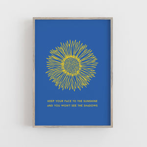 antdesigngifts.co.uk Sunflower art print with blue background and yellow flower. Quote Keep you face to the sunshine and you won't see the shadows. Ukraine flag colours. Blue and yellow. Charity print.